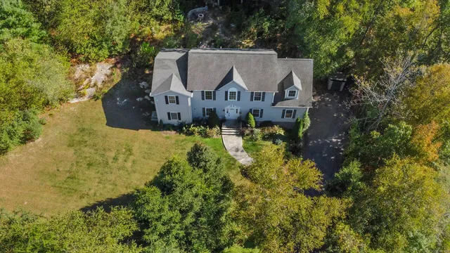 an aerial view of a house with a yard