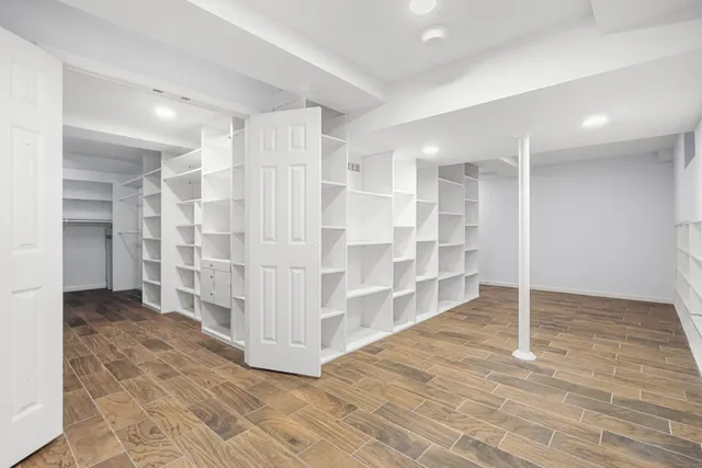 a view of empty room with wooden floor