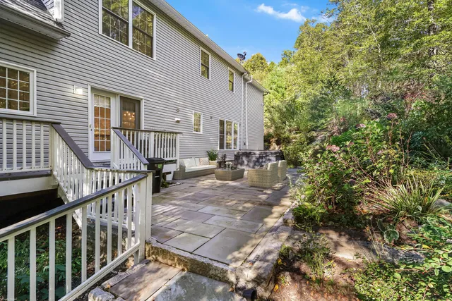 a view of a house with backyard and sitting area
