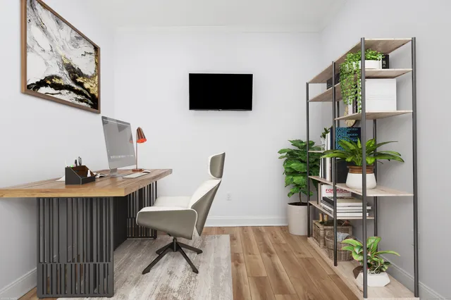 a view of a workspace with furniture and wooden floor
