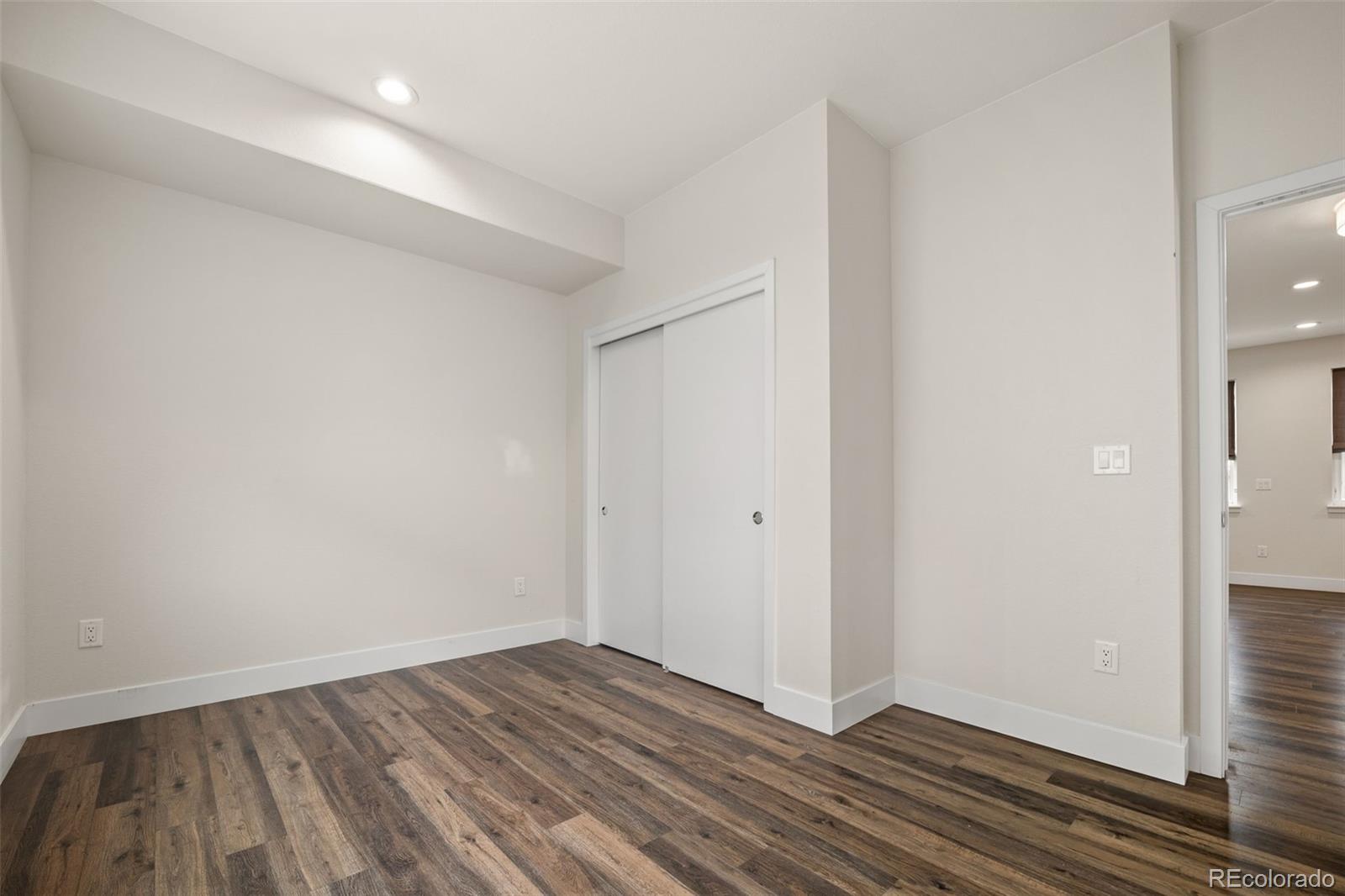 1204 South Reed Street Lakewood, CO 80232 - Photo 43 of 45 a view of an empty room with wooden floor and closet