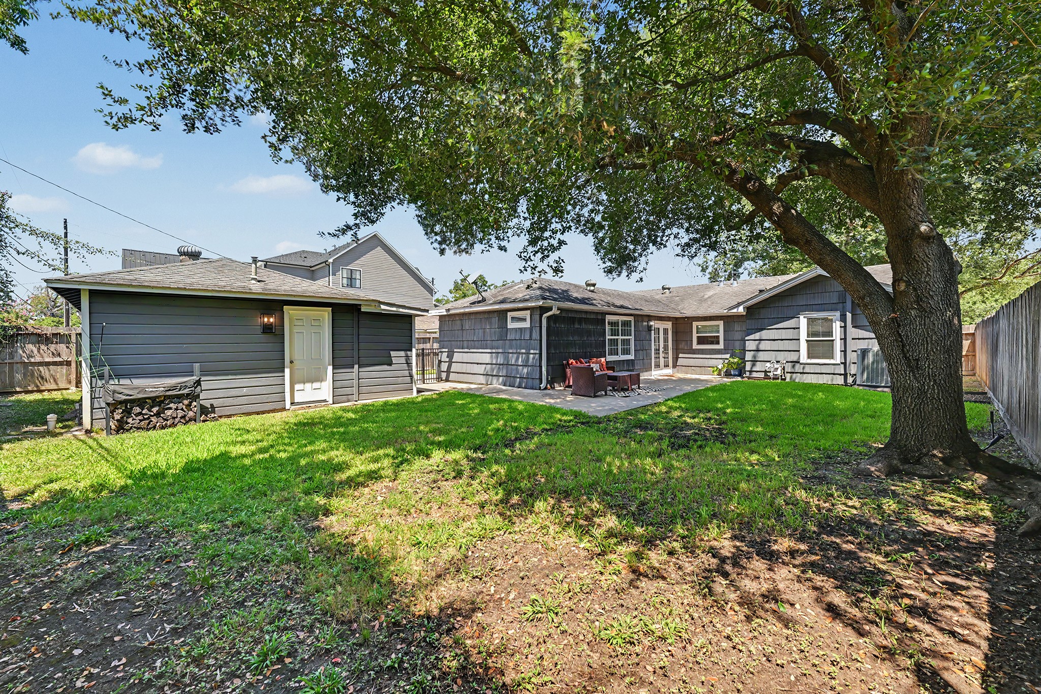 6223 Linton Road Houston, TX 77008 - Photo 22 of 30 View from the back of the yard showcases the shade tree. Two car oversized garage to the left.