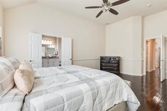 a spacious bedroom with a bed and a chandelier
