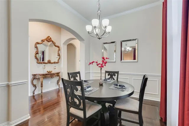 a view of a dining room with furniture and chandelier