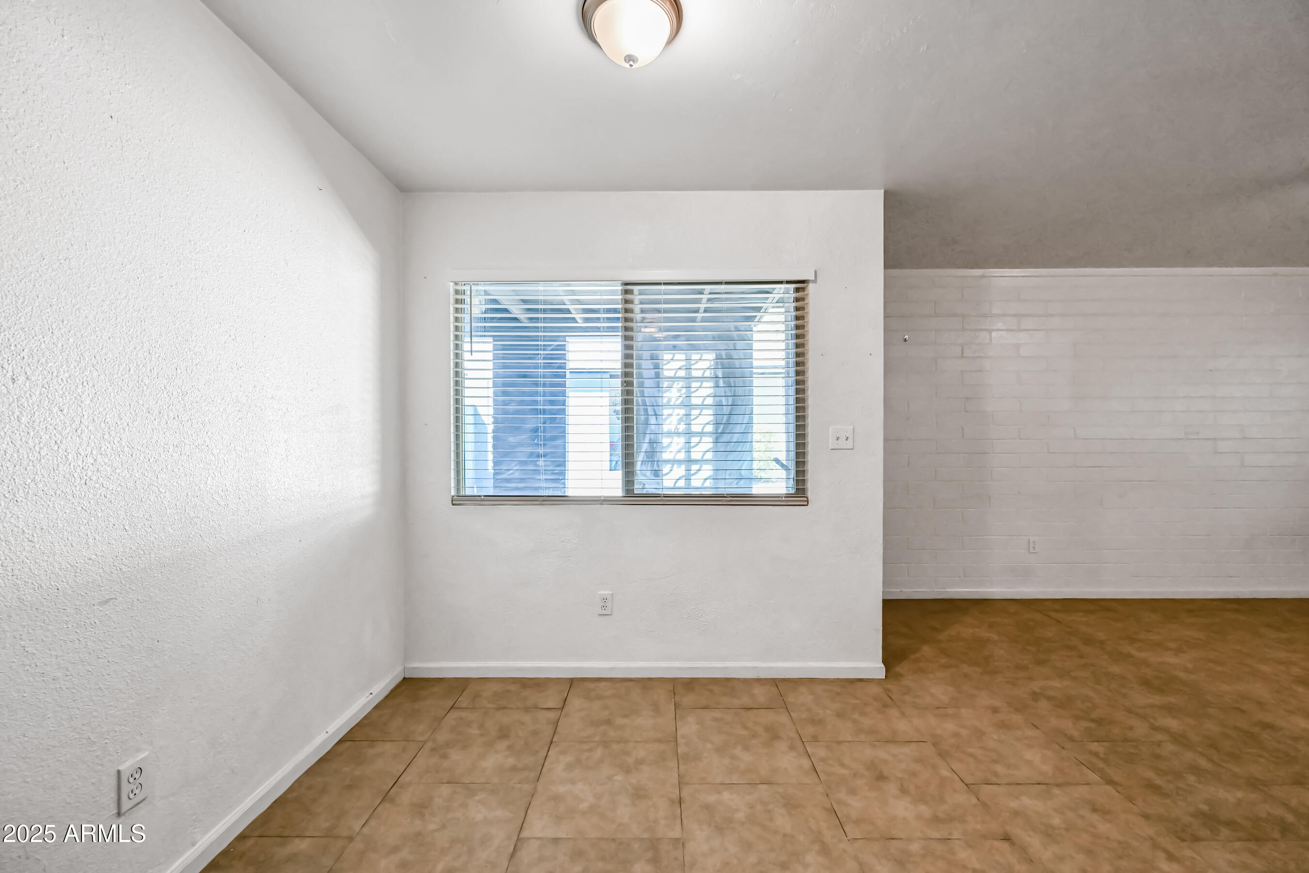 1518 West Colter Street, Unit 29 Phoenix, AZ 85015 - Photo 11 of 15 an empty room with windows
