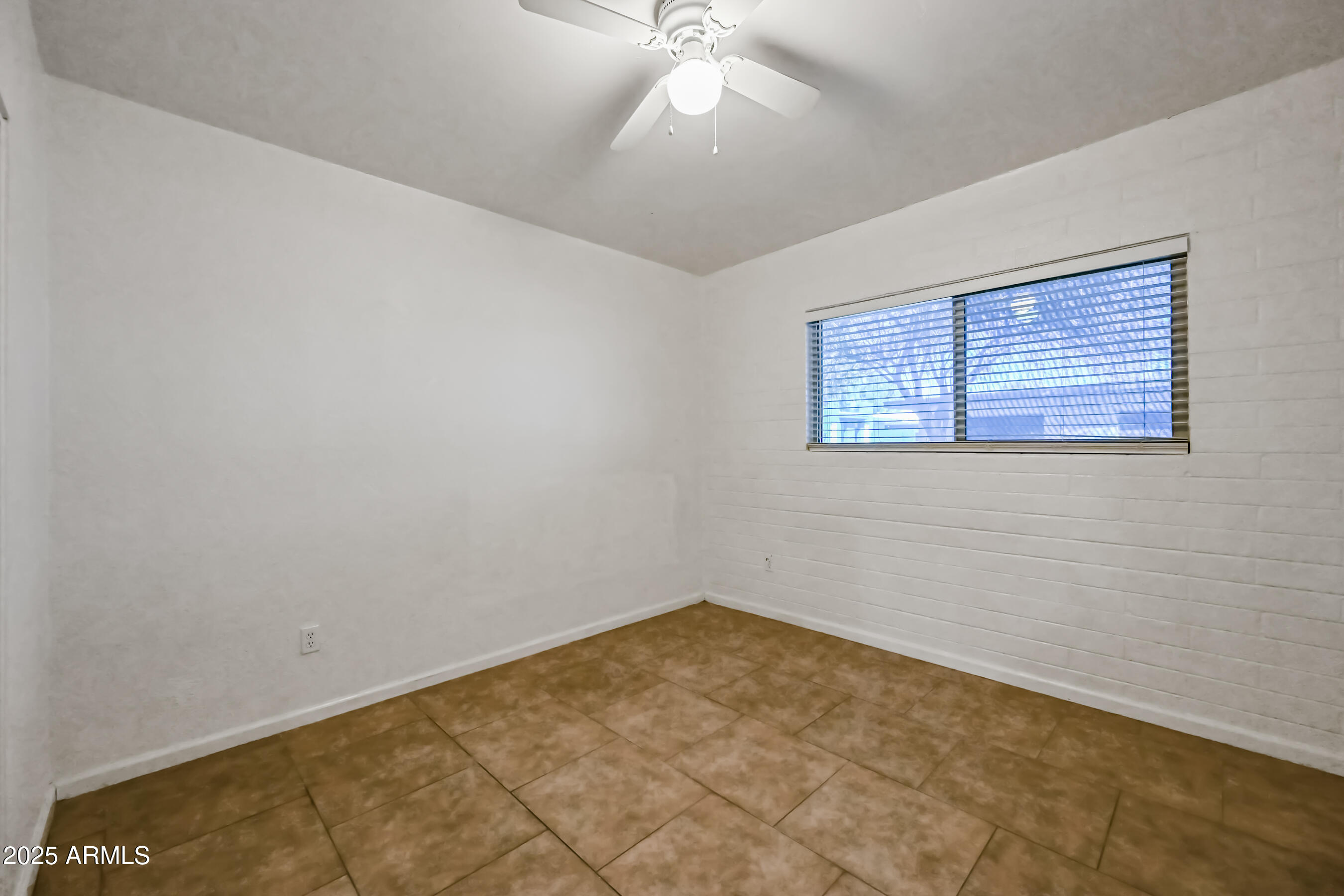 1518 West Colter Street, Unit 29 Phoenix, AZ 85015 - Photo 13 of 15 a view of an empty room with a window