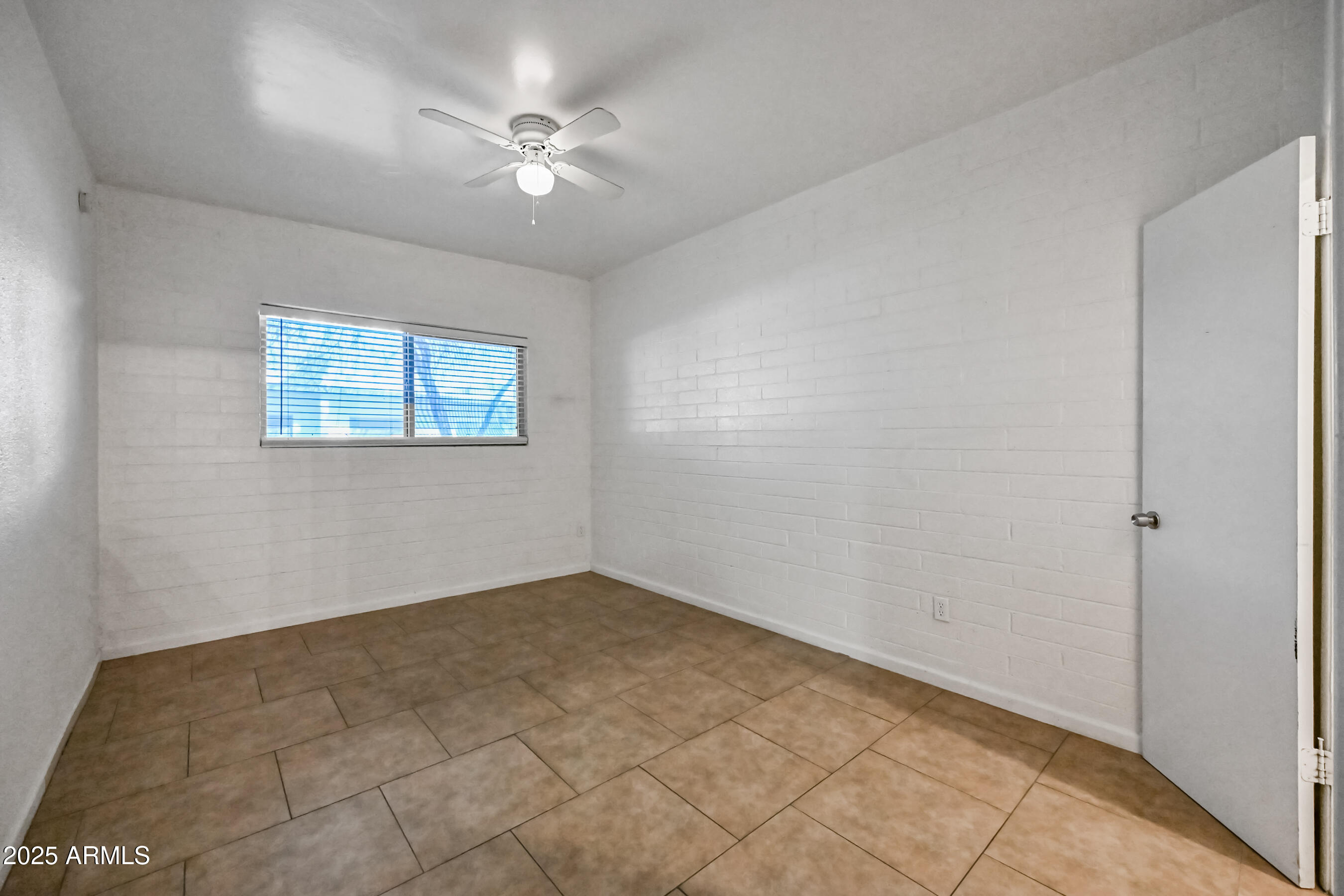 1518 West Colter Street, Unit 29 Phoenix, AZ 85015 - Photo 14 of 15 a view of an empty room with a window