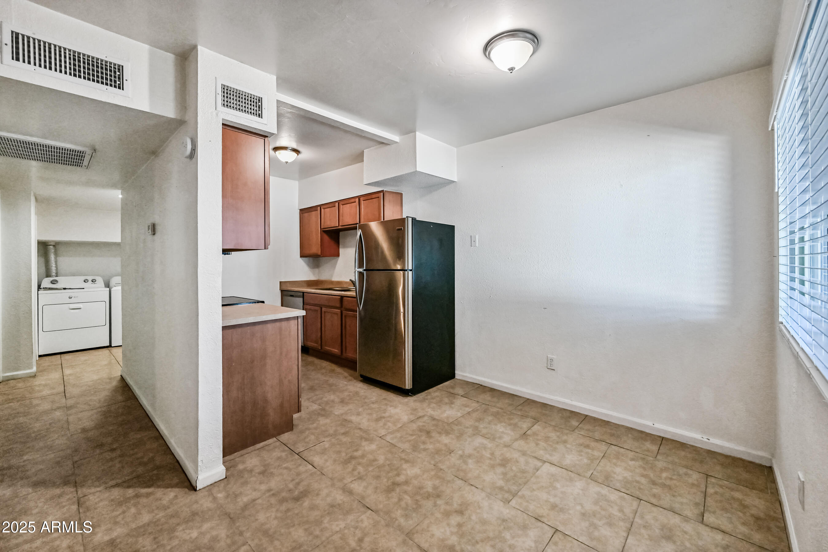 1518 West Colter Street, Unit 29 Phoenix, AZ 85015 - Photo 7 of 15 a kitchen with refrigerator and window