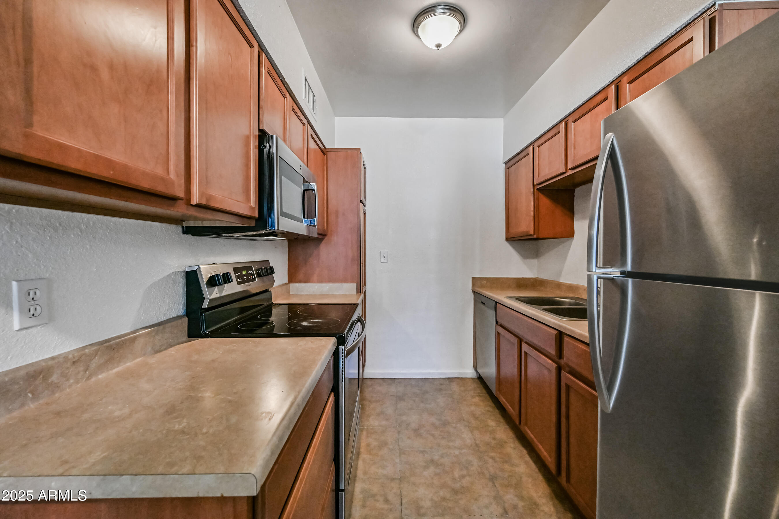 1518 West Colter Street, Unit 29 Phoenix, AZ 85015 - Photo 8 of 15 a kitchen with stainless steel appliances granite countertop a refrigerator a stove top oven a sink and dishwasher