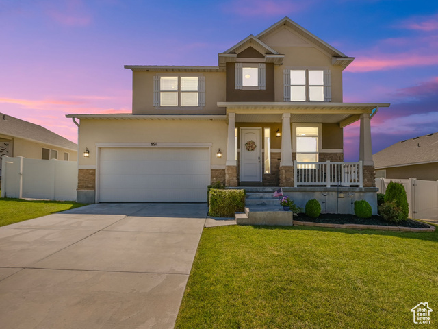 891 North 200 West Tooele, UT 84074 - Photo 1 of 1 View of front of house with a covered porch and a yard