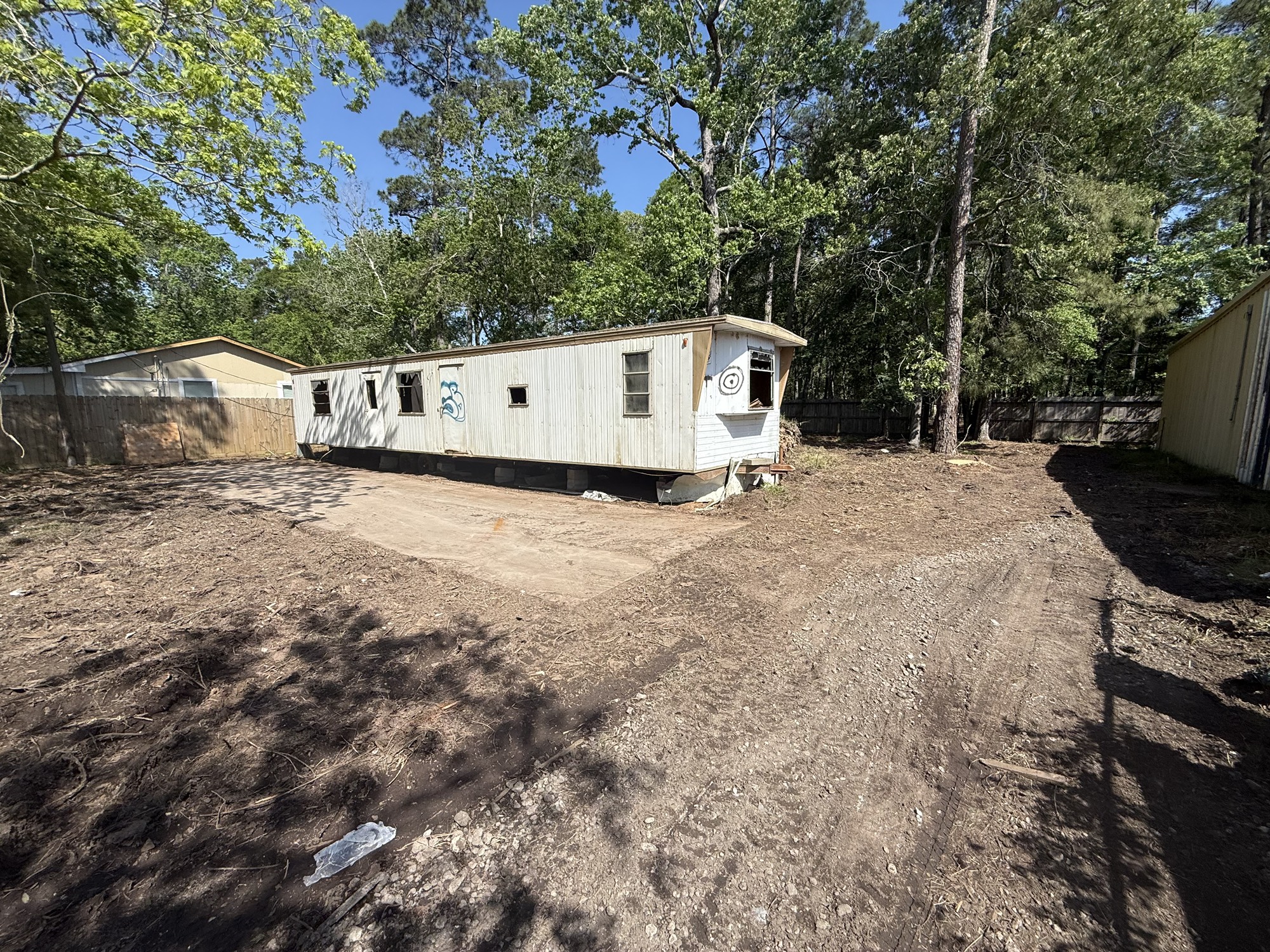 a white house that has a tree in front of it