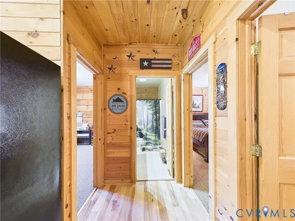 a view of a hallway with wooden floor and entryway