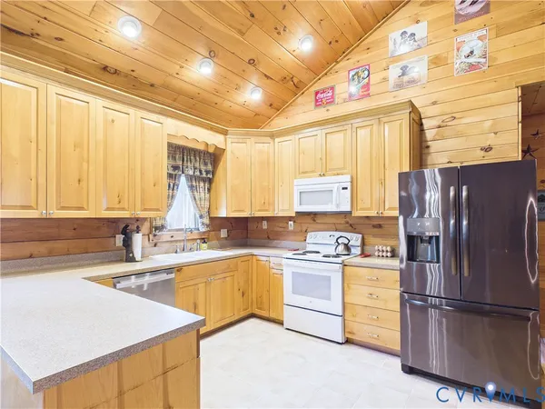 a kitchen with a sink a refrigerator and window