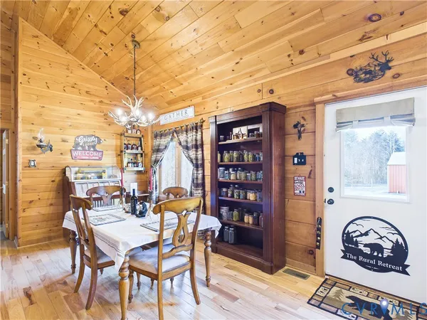 a dining room with furniture and wooden floor