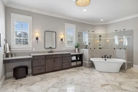 a spacious bathroom with a double vanity sink mirror and bathtub