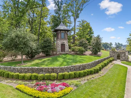 a view of a garden with a fountain and a big yard