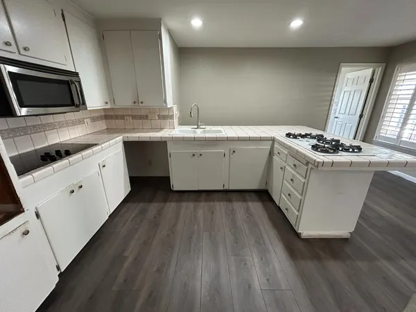 a kitchen with a sink stove and microwave