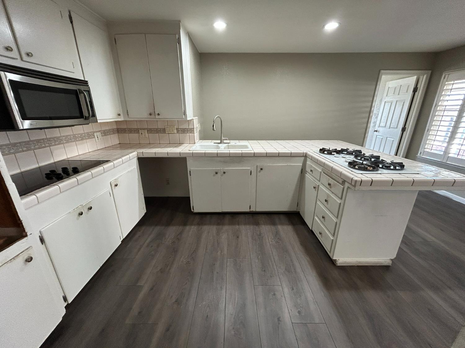 a kitchen with a sink stove and microwave