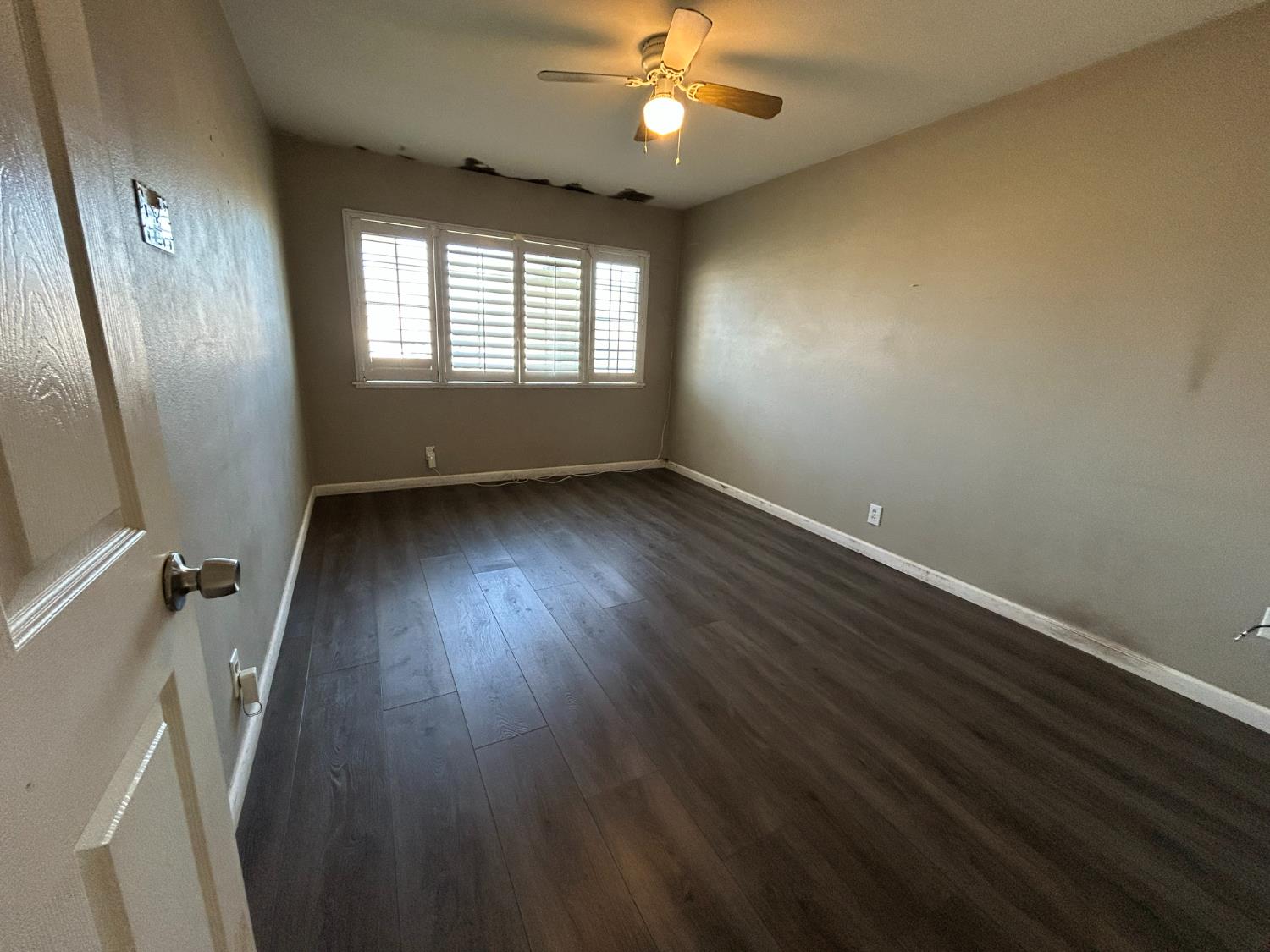 2581 Ballantyne Drive Merced, CA 95341 - Photo 4 of 16 wooden floor in an empty room with a window