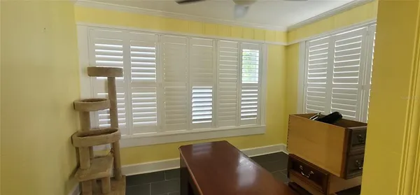 a view of a dining room with furniture and windows