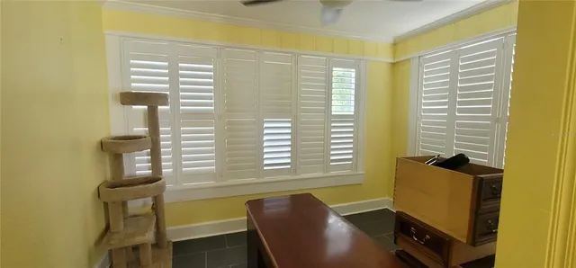 a view of a dining room with furniture and windows