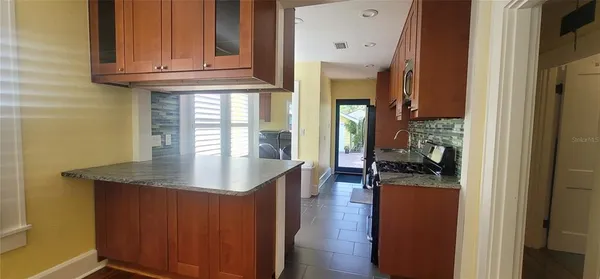 a kitchen with stainless steel appliances granite countertop a refrigerator and a stove