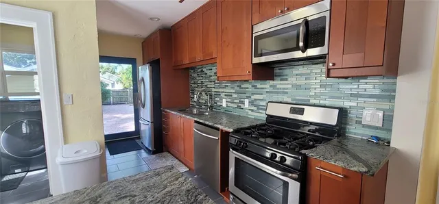 a kitchen with a stove and a microwave