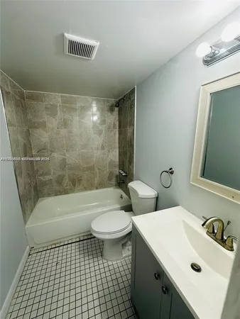 a bathroom with a sink a toilet and bathtub