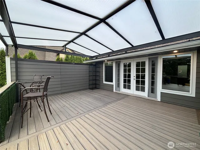 a view of deck with table and chairs and wooden floor