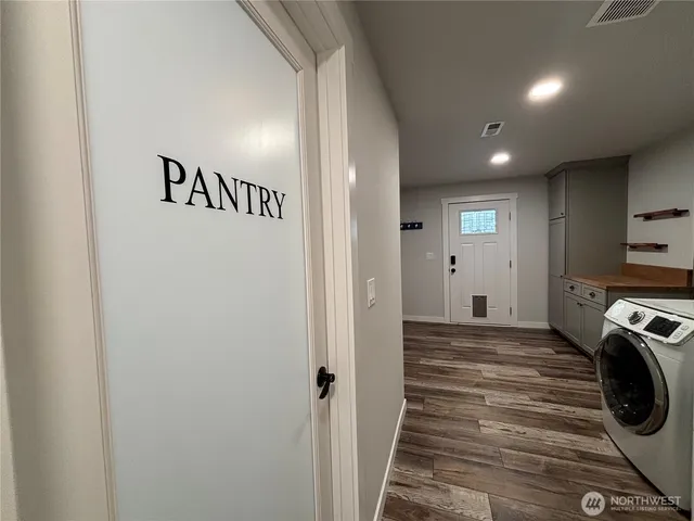a view of a hallway with washer and dryer