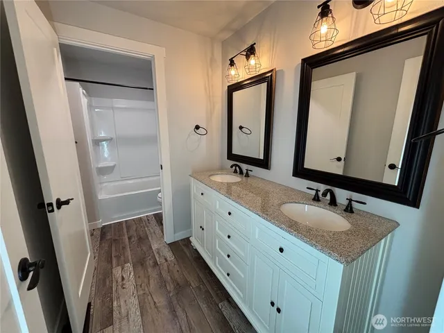 a bathroom with 2 sink and a mirror