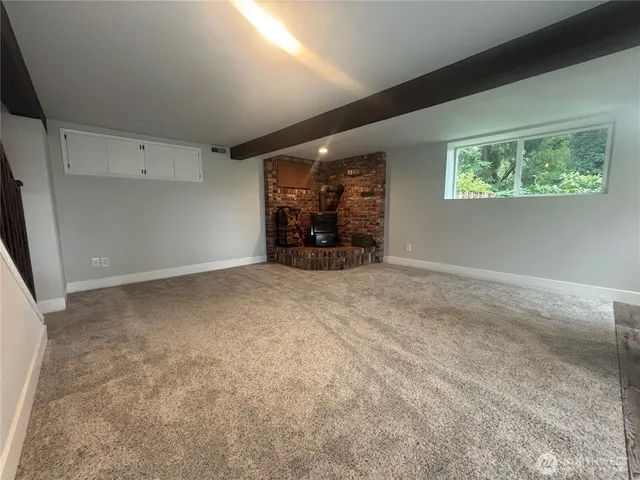 a room with fireplace and outdoor seating