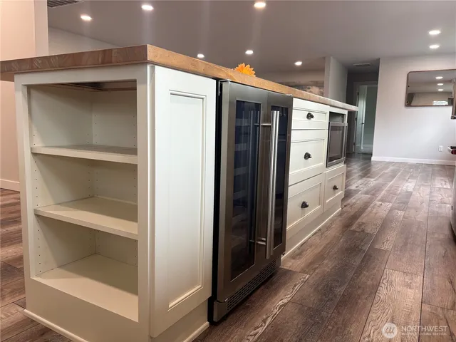 a large kitchen with granite countertop a refrigerator and a stove