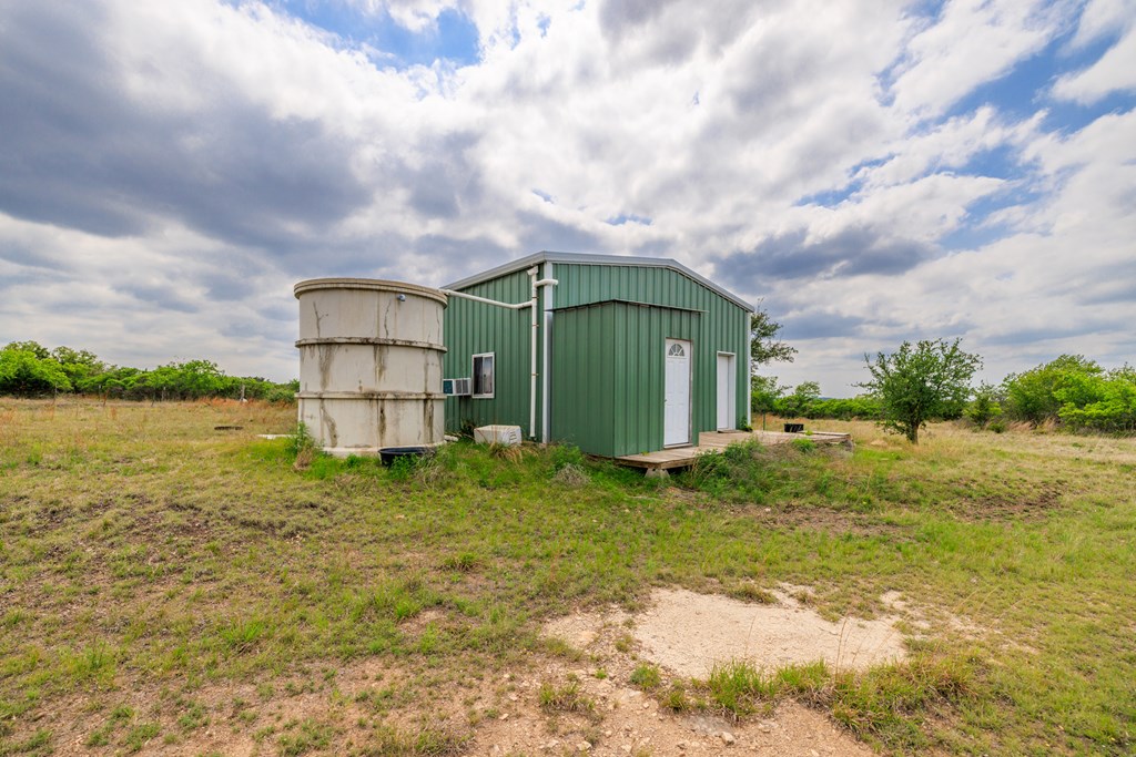 3276 Link Road Doss, TX 78618 - Photo 13 of 44 a backyard of a house with lots of green space and lake view