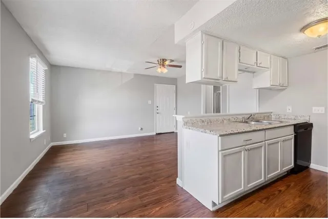 a kitchen with stainless steel appliances granite countertop a sink stove and cabinets