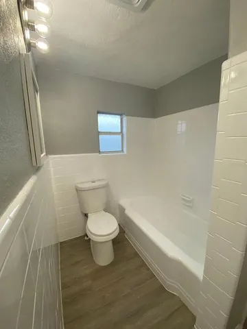 a bathroom with a toilet a sink and shower