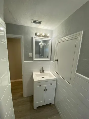 a bathroom with a sink a toilet a mirror and vanity