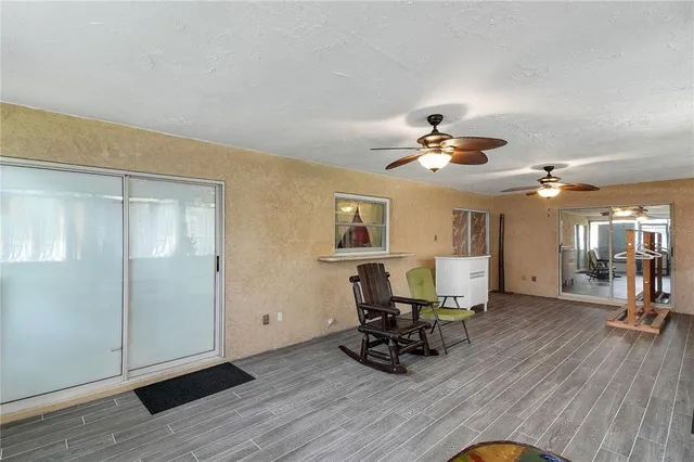 a view of a livingroom with furniture and a ceiling fan