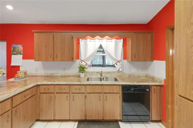 a kitchen with a sink cabinets and a wooden floor