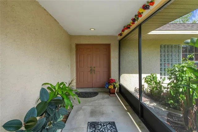 a balcony with potted plants and brick walls
