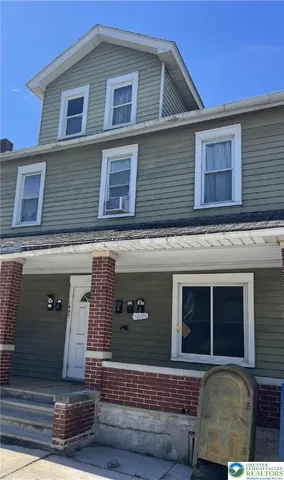 a view of a house with more windows and garage