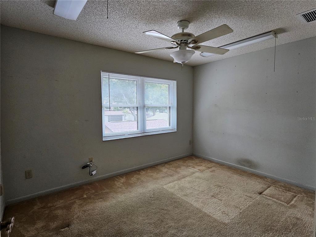 3418 West St Conrad Street Tampa, FL 33607 - Photo 18 of 24 an empty room with windows and fan