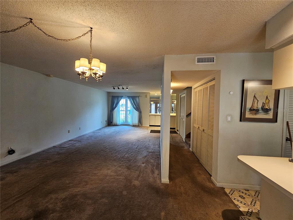 3418 West St Conrad Street Tampa, FL 33607 - Photo 5 of 24 a view of a hallway with a chandelier