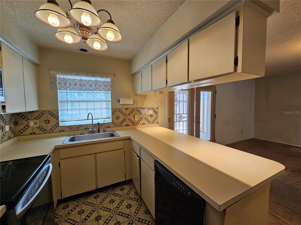 3418 West St Conrad Street Tampa, FL 33607 - Photo 7 of 24 a kitchen with a sink cabinets and window