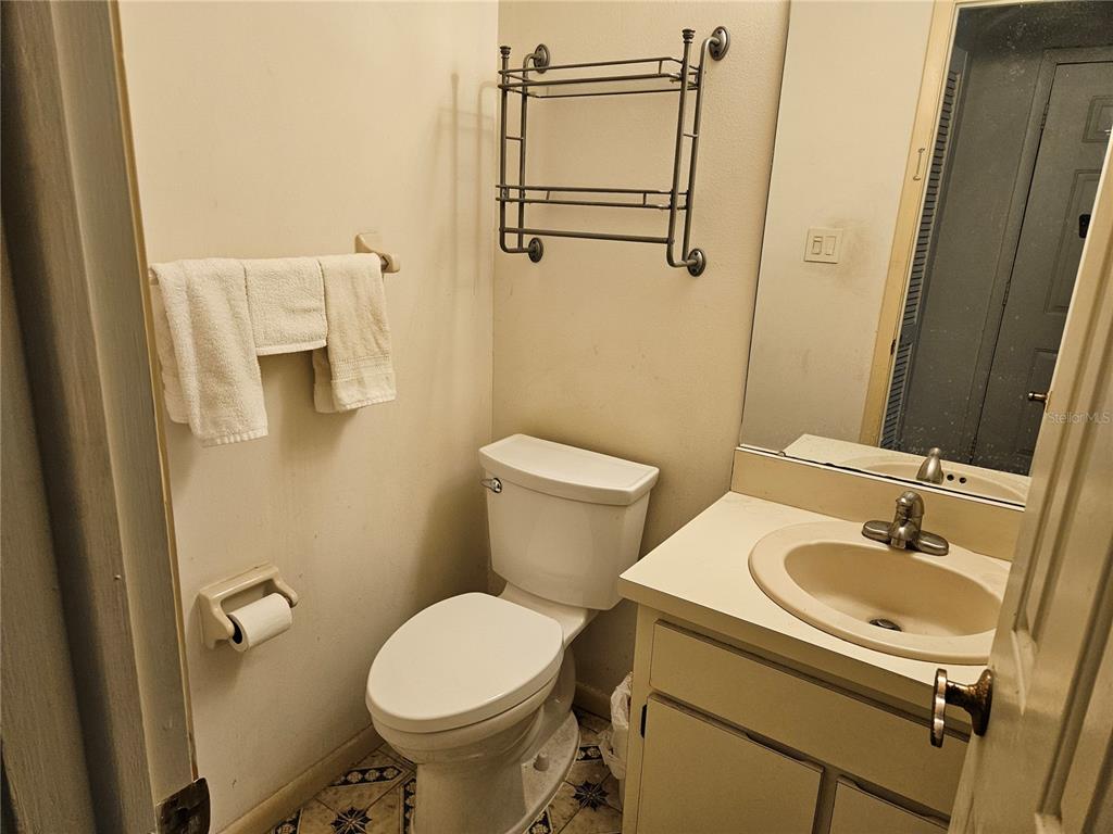 3418 West St Conrad Street Tampa, FL 33607 - Photo 8 of 24 a bathroom with a sink toilet and a mirror