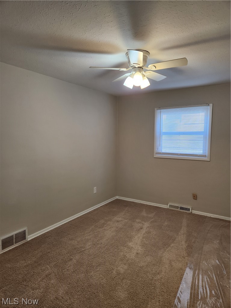 4660 West Farnhurst Road South Euclid, OH 44121 - Photo 10 of 17 Carpeted empty room featuring ceiling fan and a textured ceiling