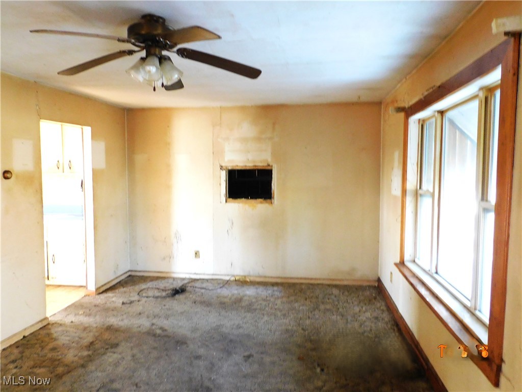 352 South Ridge Road East Conneaut, OH 44030 - Photo 6 of 21 Carpeted empty room with ceiling fan and baseboards