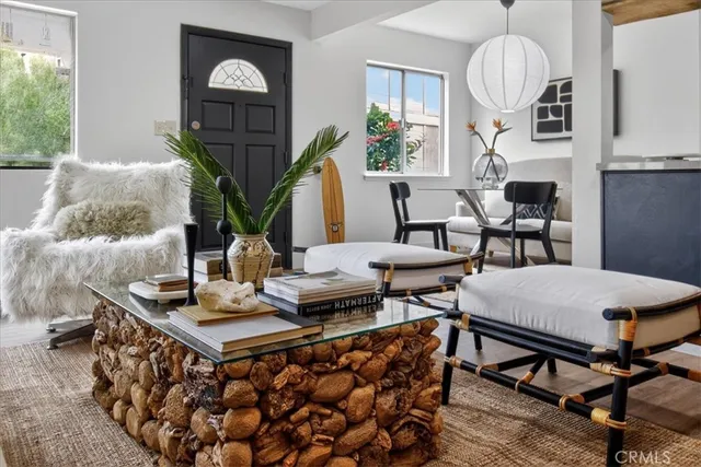 a living room with furniture a chandelier and a table