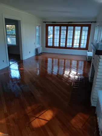 wooden floor in a hall with wooden floor and a window