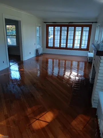 wooden floor in a hall with wooden floor and a window